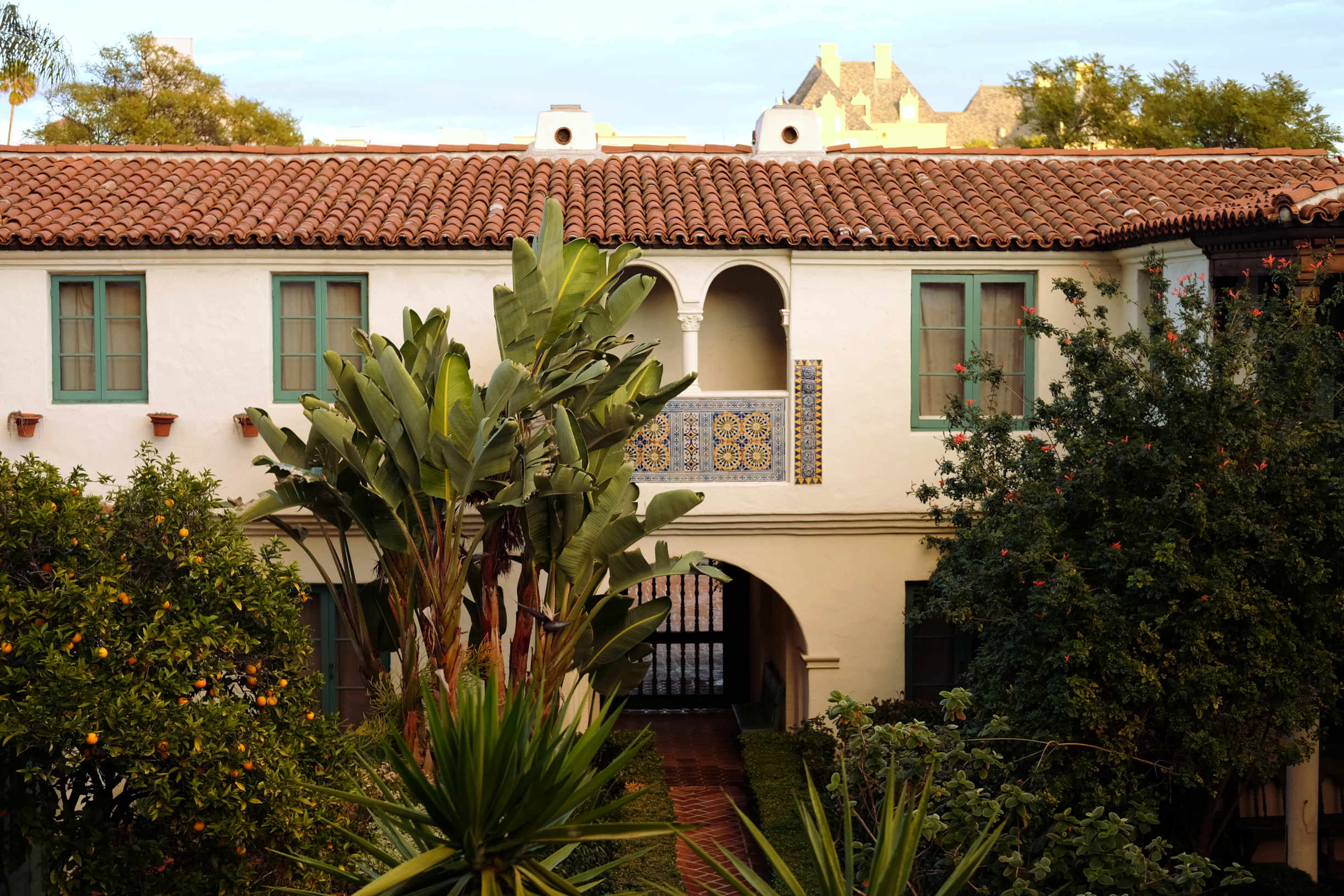 Hollywood Spanish Colonial or Mediterranean style courtyard with Chateau Marmont in background