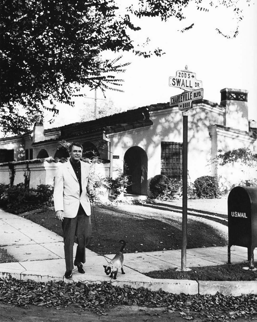 Cary Grant in front of Hollywood Spanish Colonial or Mediterranean style home