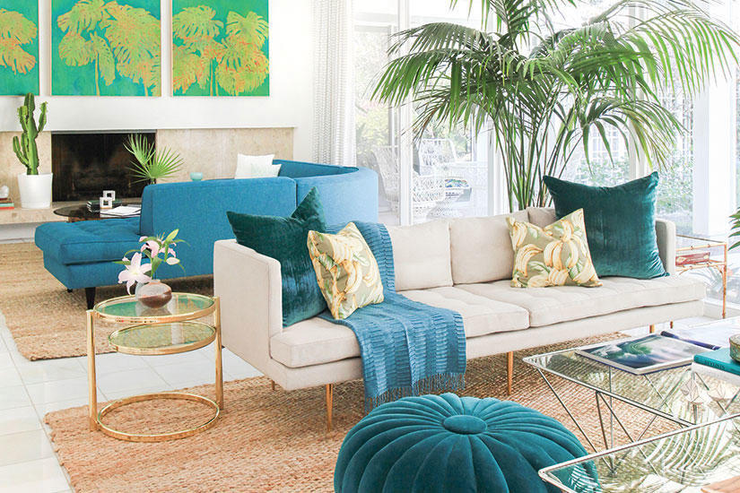 Teal ottoman with turquoise pillows and throw, palm tree and tropical influence